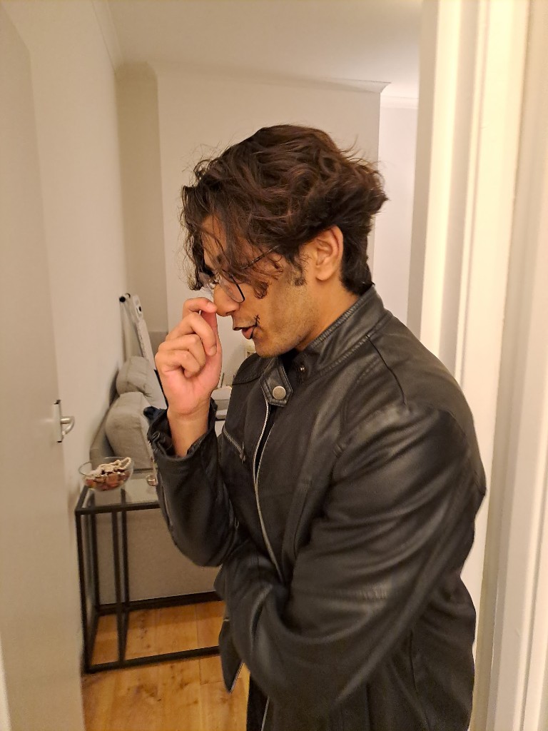 Portrait in profile, hand near face, leather jacket